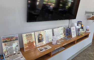 TLIG posters and flyers on a church display shelf