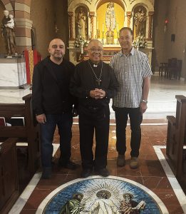 Archbishop Arguelles with Deacons Art and Ed in front of the church altar