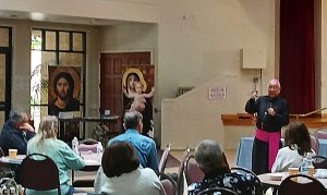 Archbishop Arguelles speaking to retreat attendees in the parish hall