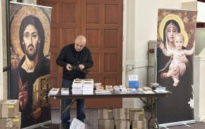 TLIG book table with Jesus and Mary banners at the retreat